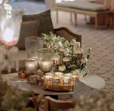 This may contain: a table with candles and flowers on it