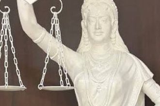 Blindfold replaced with open eyes, sword by Constitution in new Justice statue in SC