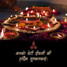 This may contain: a decorated plate with lit candles on it in front of a quote that reads, happy diwali